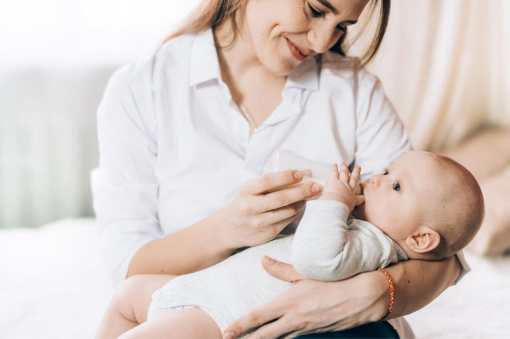 Combination Feeding: The Solution for Every Busy Mom 4 Caring Mother Bottle Feeds Her Newborn Baby