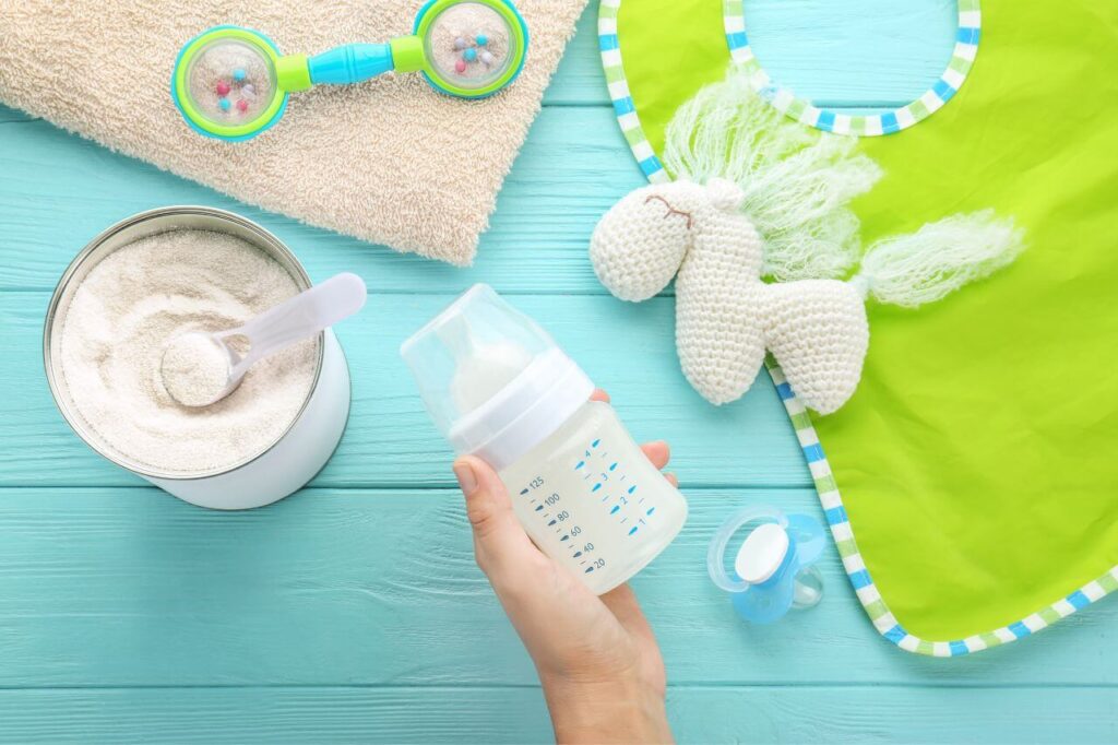 Formula Feeding And Breastfeeding: What is Best for Your Baby? 3 Person holding feeding bottle of baby milk formula