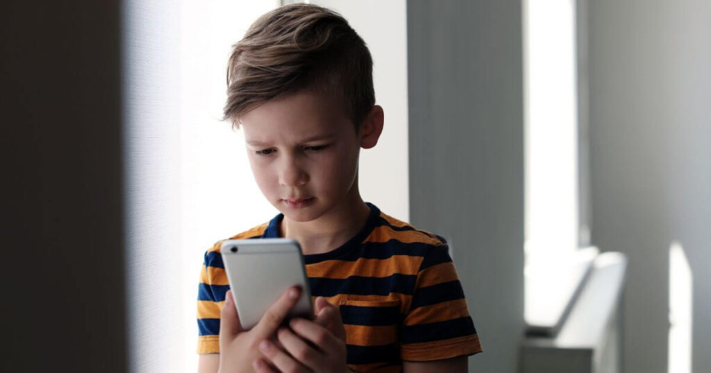 How Much Screen Time Is Too Much for your Kid? 2 Child Using A Mobile Phone