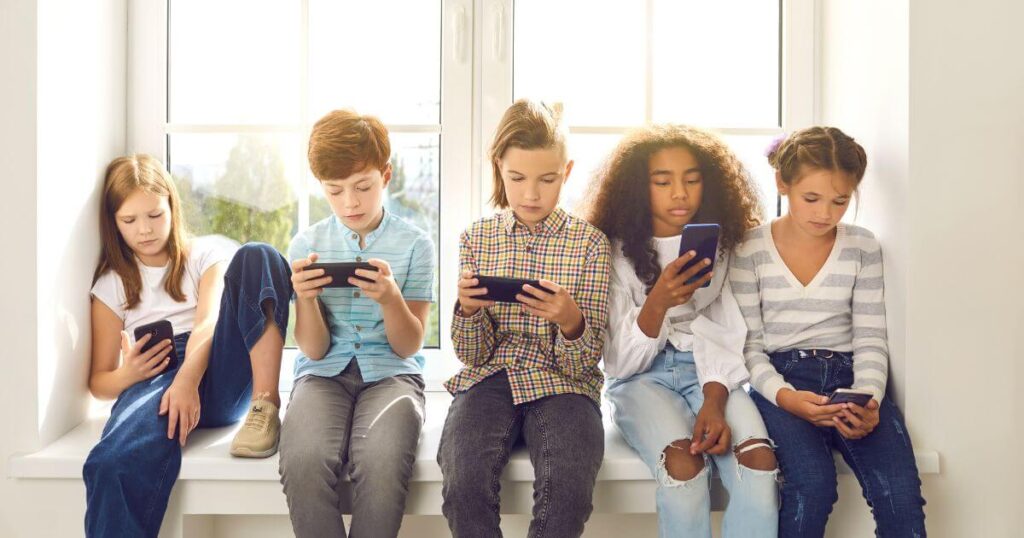How Much Screen Time Is Too Much for your Kid? 4 Children Using Mobile Instead Of Playing