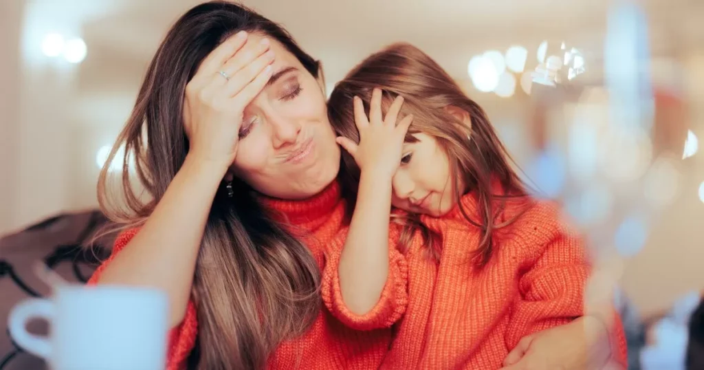 Effective Strategies To Improve Your kid's Reading Comprehension Skills 6 A mother and child, both dressed in matching orange sweaters, look overwhelmed and frustrated, each with their hand on their forehead, conveying a sense of shared stress or confusion.